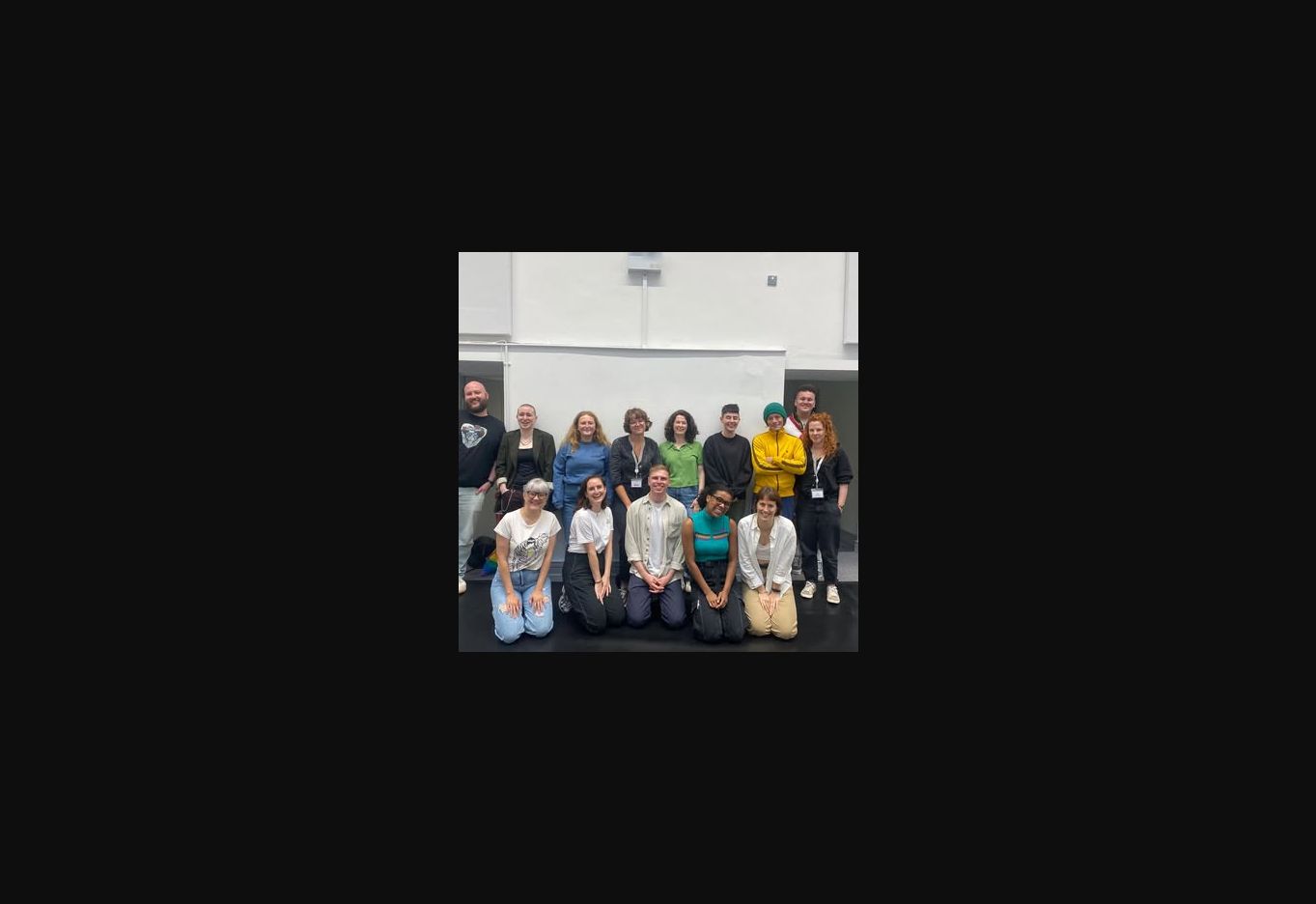 A theatre company gathered for a group photograph